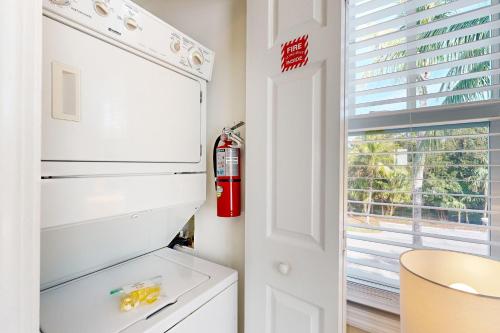 a white refrigerator in a kitchen with a window at Restful Retreat in Duck Key