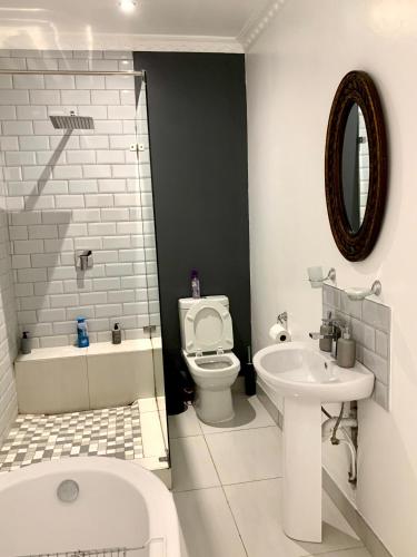 a bathroom with a toilet and a sink at Modern apartment, a home away from home 266 in Summerstrand