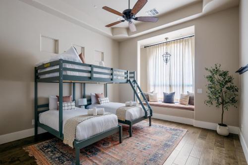 a bedroom with two bunk beds and a ceiling fan at Luxe Poolside Paradise - Resort Style Yard in Scottsdale