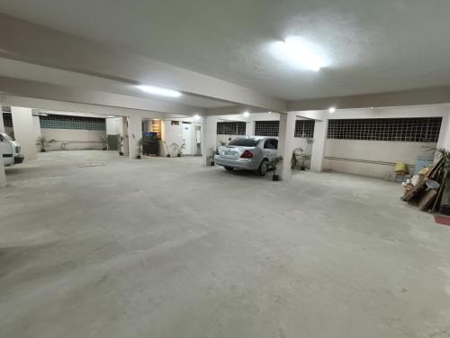 an empty garage with a car parked in it at Hotel Classic Comfort in Bengaluru