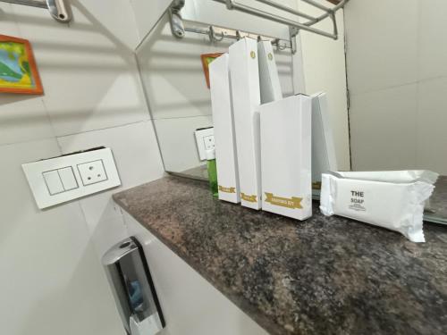 a bathroom with a counter with white towels on it at Hotel Classic Comfort in Bengaluru