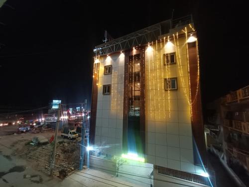 a building with lights on it at night at Hotel Classic Comfort in Bengaluru