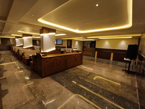 a lobby with a waiting room with chairs and a counter at Hotel Classic Comfort in Bengaluru