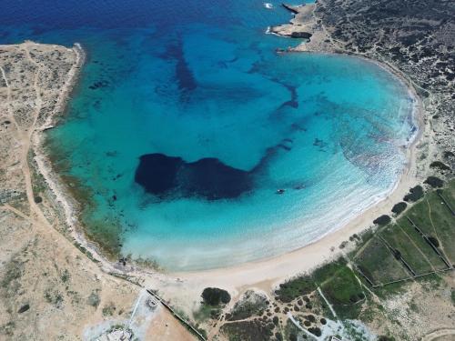 an aerial view of a beach with blue water at CycladesCharters: Discover Hidden Gems in Paros! in Kampos Paros