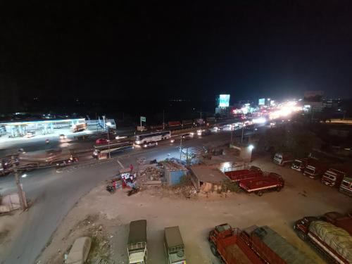 a busy city street at night with cars and buses at Hotel Classic Comfort in Bengaluru