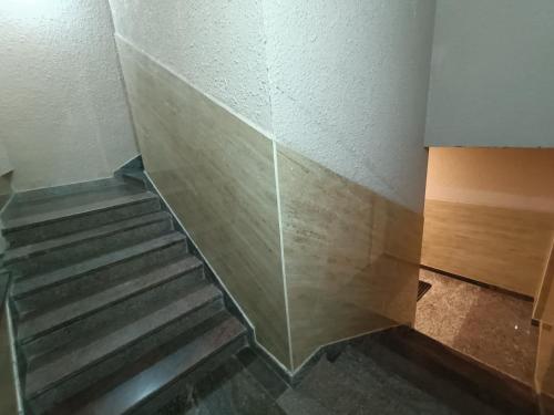 a staircase in a room with a glass wall at Hotel Classic Comfort in Bengaluru