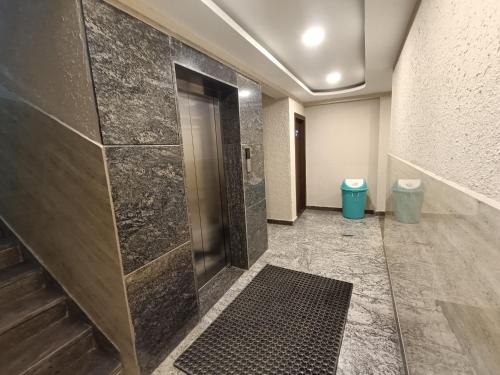 a bathroom with a shower and two trash cans at Hotel Classic Comfort in Bengaluru
