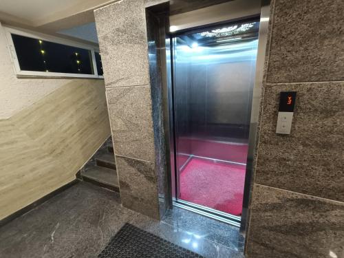 a elevator with a red floor in a building at Hotel Classic Comfort in Bengaluru