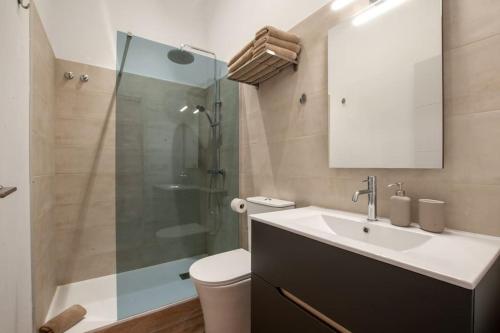 a bathroom with a sink and a glass shower at La Casa de San Juan - Tenesor in Telde