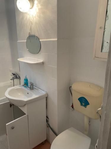 a small bathroom with a toilet and a sink at Blu Azure in Cluj-Napoca