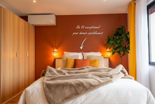 a bedroom with a bed with a blanket on it at Studio Delorme in Bagneux