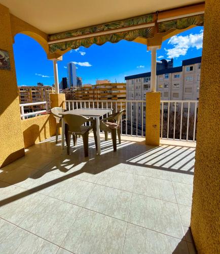 a patio with a table and chairs on a balcony at Apartamento Apolo 7 centro 250m playa in Calpe