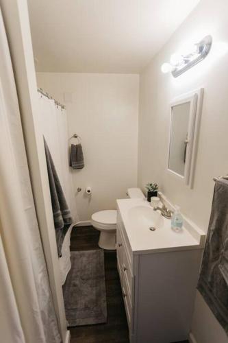 a white bathroom with a sink and a toilet at Stylish & Cozy Home in Dayton-Close to Everything! in Dayton