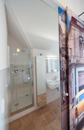 a bathroom with a shower and a sink at Hotelpension Vitalis in Bad Hersfeld