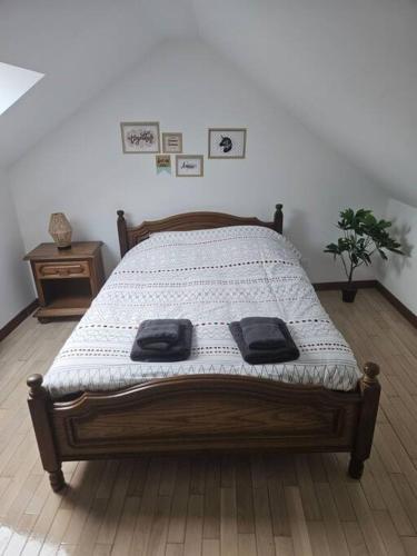 a bedroom with a bed with two towels on it at La petite bulle in Villeneuve-sur-Yonne
