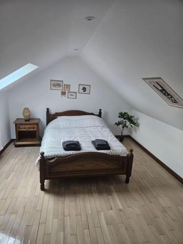 a bedroom with a bed and a wooden floor at La petite bulle in Villeneuve-sur-Yonne