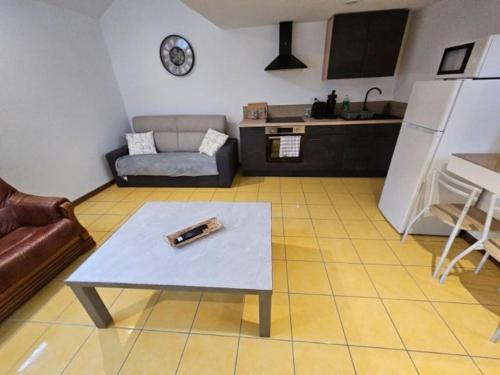 a living room with a couch and a coffee table at La petite bulle in Villeneuve-sur-Yonne