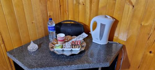 a table with a drink bottle and a basket of food at Alojamiento Villa Doralis in Guatavita