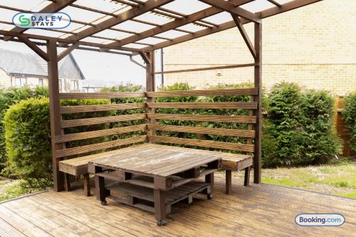 a wooden pergola with a wooden picnic table on a deck at Lovely 3 bed Home for contractors, families, groups - Gated parking in Manchester