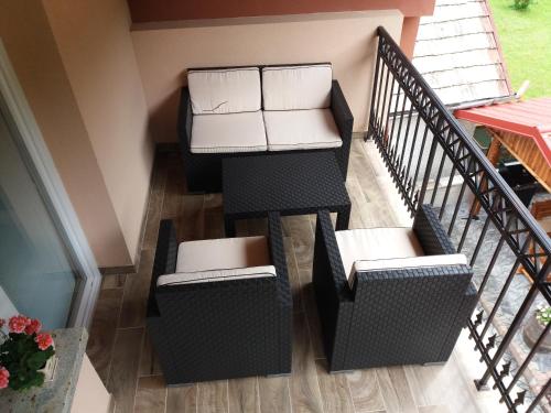a balcony with two chairs with boxes on them at Chata Remata 879 in Handlová