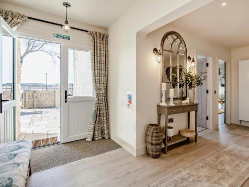 a living room with a door leading to a patio at 6 Bed in South Queensferry 94359 in Broxburn