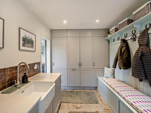 a kitchen with white cabinets and a sink at 6 Bed in South Queensferry 94359 in Broxburn