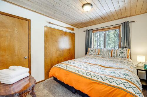 a bedroom with a bed and a window at Woodland Park Chalet with Deck, Grill and Mtn Views! in Woodland Park