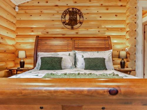 a bedroom with a bed in a log cabin at 3 Bed in Brinsley 93794 