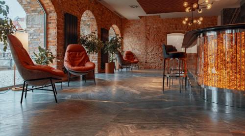 a lobby with chairs and a barber shop at Radisson Hotel & Suites, Gdansk, Wyspa Spichrzów in Gdańsk