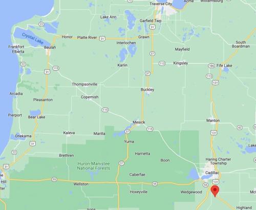 a map of nigeria with a red marker at 5BR Lakefront Getaway with hot tub in Cadillac