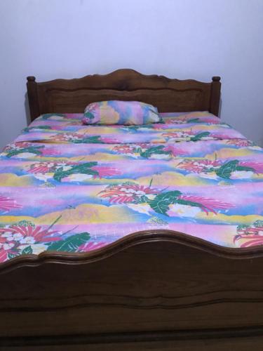 una cama con un edredón colorido encima en La Villa Ingrid en Antsiakambony