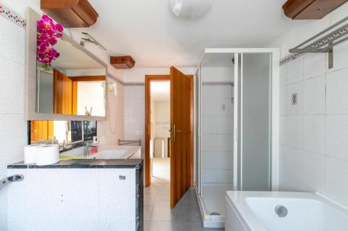 a bathroom with a tub and a sink at San Marco in Venice