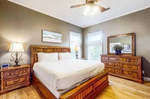a bedroom with a large bed and a ceiling fan at Reel Memories in St. George Island