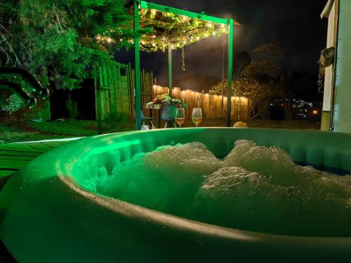 una bañera llena de agua en un patio por la noche en Waira home, en Guarne