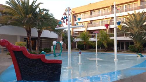 a pool with a water park in front of a building at PH1401 Hotel Margarita Real in Porlamar