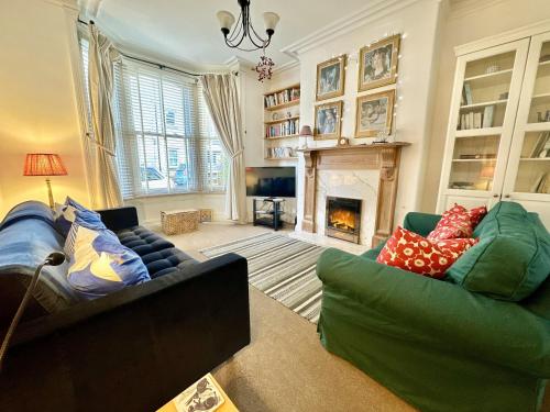 a living room with two couches and a fireplace at Nunmill Nest By Bishy Road With Free Parking in York