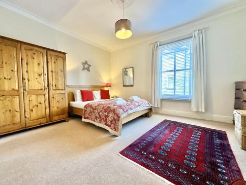 a bedroom with a bed and a large window at Nunmill Nest By Bishy Road With Free Parking in York