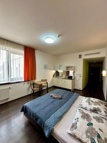 a bedroom with a large bed and a table at Apartmán priamo na hlavnej ulici in Košice