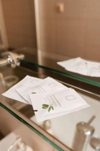 a glass table with papers on top of it at Apartmán priamo na hlavnej ulici in Košice