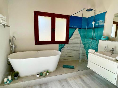 a bathroom with a tub and a shower and a sink at Villa Sun Club home in Llucmajor