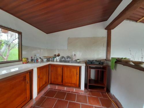 a kitchen with wooden cabinets and a window at Antahkarana Casa Hotel in San Agustín