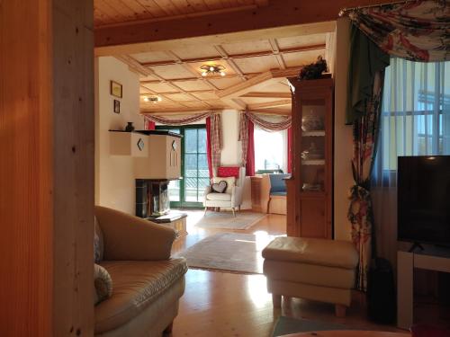 a living room with a couch and a tv at Tauern Haus in Untertauern