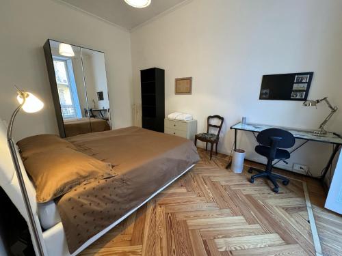 a bedroom with a bed and a desk in it at La Casa di Titilla in Turin