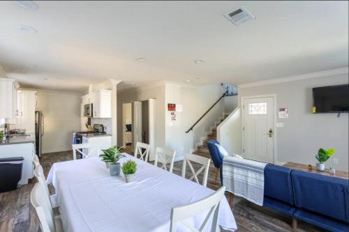 a dining room and kitchen with a table and chairs at 5 BR Home Near USC - Perfect Location in Los Angeles