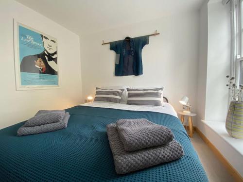a bedroom with a large bed with two pillows on it at St Benedicts Street Flat with Roof Terrace in Norwich