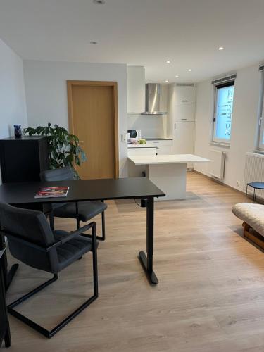 a living room with a table and a chair at Côté Source " Appartement " in Francorchamps