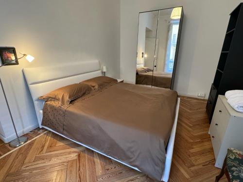 a large bed in a room with a mirror at La Casa di Titilla in Turin