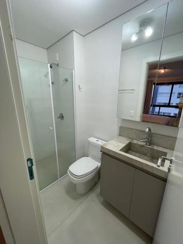 a bathroom with a toilet and a shower and a sink at Vesta - melhor localização Torres in Torres
