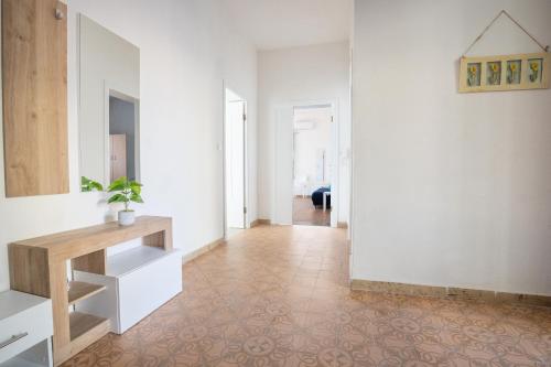 a hallway with white walls and a tile floor at "Tramontana" vista mare - 300m dalla spiaggia in Golfo Aranci