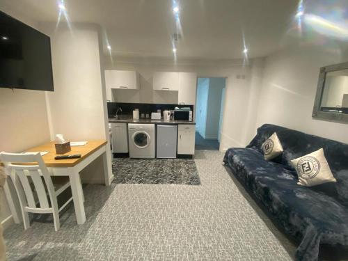 a living room with a couch and a table at Beautiful 3-Bed apartment in Merthyr Tydfil in Merthyr Tydfil